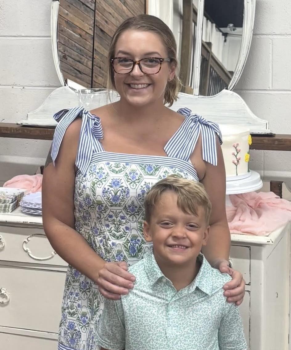 A young mother is fighting for her life after she was shot five times inside her apartment, shielding her 6-year-old son from the gunfire.